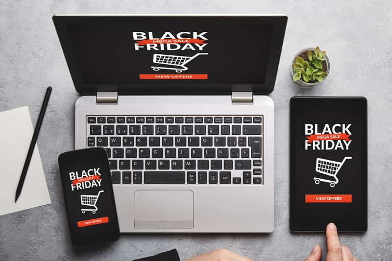 Laptop, smartphone, and tablet each showcasing 'Black Friday' screens, representing cross-device online shopping readiness